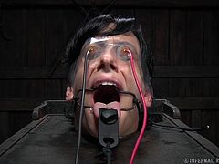 Elise tries to scream for help, but the word can't be made out because of the clamps around her mouth and tongue. He master turns up the power on the electrodes attached to her face and pussy and she nearly passes out.