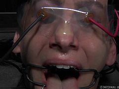 Elise tries to scream for help, but the word can't be made out because of the clamps around her mouth and tongue. He master turns up the power on the electrodes attached to her face and pussy and she nearly passes out.