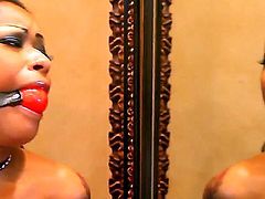 Skin Diamond wears a very peculiar outfit, and this way she looks more beastly and dangerous. The lass shuts her mouth with pink ball and stimulates her coochie with big vibrator.