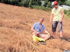 A twink is walking down the street when he sees a path. He walks down the path and sees another twink in the middle of the field jacking of. He offers to sucks his cock. They have gay sex and cum all over each other.