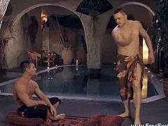 See two horny gay studs massaging their muscular bodies before enjoying a hot handjob.