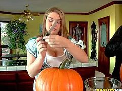 Voodoo and Cassandra Calogera get ready for Halloween together. Naturally busty clothed girl with her hands on pumpkin gets her juicy boobs grabbed by curious guy. He loves her juicy melons.