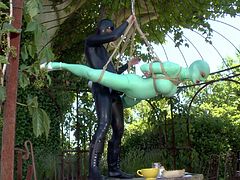 Latex Lucy is helpless outdoors in suspension bondage. She gets her mouth and vagina fucked by mistress in rubber outfit. Watch her get strapon fucked with no mercy in the garden.