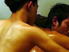 See a horny Asian gay hunk getting his body massage by a naughty stud.