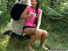 Naughty teen gets dirty with kinky panda bear. He flirts with her, she gets naked and ends up sucking his huge rubber cock.