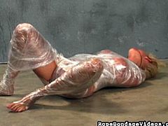 Even though clad in a plastic wrap, this horn blonde babe still manage to spread her legs wide apart and tear some of it for she can please her craving pussy with a toy dick.