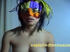 Anna is a Filipina teen who gets her twat pounded hard. She is wearing a carnival mask and stockings.
