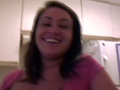 Big breasted pornstar Charley Chase with bra busting boobs is so cute in the comfort of her home. Girl with charming smile flashes her nice big titties in the kitchen in front of the camera.