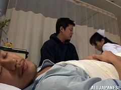Salacious Japanese nurse is having fun with two dudes in a hospital ward. She sucks their cocks hungrily and then gets her wet coochie pounded deep and hard.