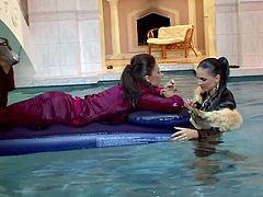 Sexy lezzies are bathing in water in their clothes. Tracing their hands over each other's bodies they get horny. So, they start spicy lesbian sex right in the pool.