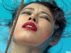 Watch this bondage video where a sexy Asian babe's tortured by her master before almost drowning as she dipped in a pool while tied up.