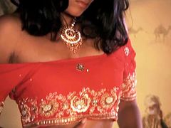 Mesmerizing Indian babe takes off her exotic costume to rub a pair of tiny perky tits and later finger her soaking vagina in front of cam in steamy solo sex video by Indian Sex Lounge.