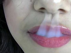 Horny latina is eager to play with her shaved twat while smoking