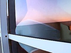 This flatchested little whore stands by a window, fully nude, for the world to see. And, lucky us, cameras, too. So, if you like em pale, redheaded, and a little quirky, unzip.