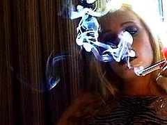 Blonde with big tits likes smoking and posing nude in the same time
