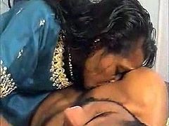 Dark skinned Desi mommy takes off her sari and strokes her wet hairy pussy. Her hubby comes in and joyfully licks her bearded clam.