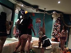 This Christmas party is full of nasty sluts. There is a stripper pole next to the Christmas tree and the sluts take turns pole dancing. One of the dirty sluts grinds her sweet ass on a guy wearing a monkey mask. Another girl bends over and gets her pussy fingered from behind.