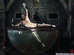 Jade Marxxx is having fun with some milf in a basement. The mistress binds Jade, plays with her coochie and then drowns the girl in a glass box.
