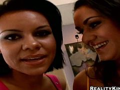 Two playful brunette milfs visit their long-term married neighbor while his wifey is out. They sit in front of him on the couch tongue fucking each other's soaking vaginas in steamy FFM sex video by Reality Kings.