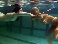 Underwater girls play with a hula hoop