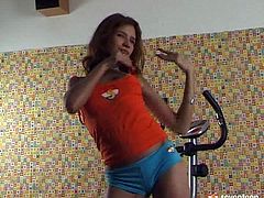 This redhead charming teen keeps her body fit by regularly working out. But this time she's on a stationary bike not to workout but to tease and eventually strip as she caress her tits and nipples.