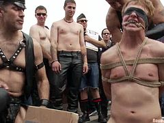 It's crazy humiliation and bondage in public for this gay guy who will also be fucked, peed on and more for the crowd's delight.