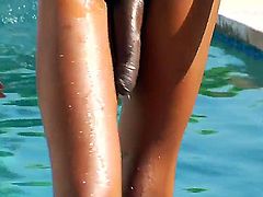 Hot ebony tranny Tameka is relaxing outdoors next to a pool by stroking her hard dick