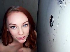 Attractive red haired floozy Dani Jensen receives a dick in her mouth and pussy through a glory hole