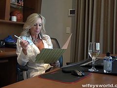 This blonde babe has massive tits which her white doctor robe can't cover. She blows a guy's cock in her medical office.