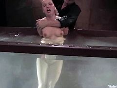 Lewd chick Katja Kassin gets bound in some foul basement. Then some guy fucks the bitch's cunt with a toy and drowns her in a glass box.