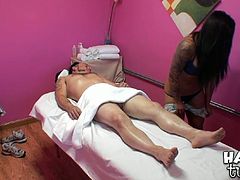 Sex greedy white tattooed dude is having a session of erotic massage. He lies on the lounge while getting his sturdy cock rubbed by a submissive Asian hottie before she welcomes his pecker inside her mouth.