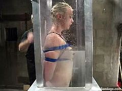 Slim blonde girl gets tied up and humiliated in BDSM video. She gets dipped in a bathtub and toyed in her vagina.