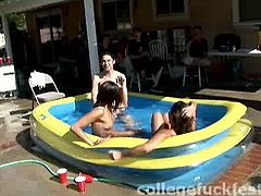 Two frisky brunette chics gets inside a pool outdoor to stroke each other's naked bodies in front of drunk folks during pool party in insane group sex orgy by Pornstar.