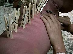 Curvaceous blond MILF gets suspended to the ceiling bandaged before an insatiable domina pinches her body with clothing pegs in peppering BDSM sex video by 21 Sextury.