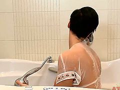 Turned on young Emlia Argan with natural juicy knockers and short black hair in white lingerie and lace undies touches her hot body in warm bathtub and stretches pink pussy.