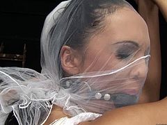 Kinky brunette bitch is fond of tough sex so she prefers BDSM games at her wedding night. Watch her getting her pussy lips stretched wide while hogtied in standing position.