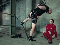 Here is the BDSM story. Dude in latex is being tortured by a mistress in latex. She puts a spreader bar on his legs and gets a full access to his ass and cock.