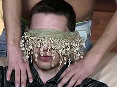 A sexy chick puts a blindfold on a guy's eyes. Another man comes into the room and starts sucking his cock. He's too horny to stop when he discovers his cock is in a man's mouth.