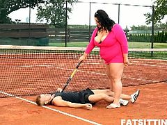 Extra large brunette dominates and facesits her tennis teacher on the tennis court outdoors and smothers him with her plumper pussy with action that lasted till dark and she scores the win in this free tube video.