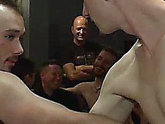 The bar is full of horny gays and Kirk Cummings is the attraction then crowd holds Kirk down as he endures the flogger then anal fucked on table