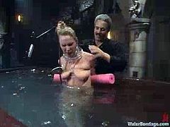 Hot chick gets tied up and then watered with powerful jet of water. After that she gets whipped and toyed hard by a fucking machine.