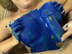 Playful blonde painter Jessica Stone gets her juicy curves covered with blue paint while teasing young stud Cris Comando and takes on his long meaty cannon with great lust.