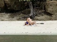 Two hot girls with nice boobs fondle each others tits and pussies. Then they suck a dick and get pounded on the beach.