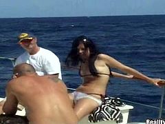 Lustful brunette babe gives a blowjob on a yacht deck. Later on she gets fingered and then fucked in her shaved pussy.