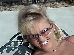 Nasty blonde MILF takes sunbathers by the pool. After some time she takes her swimsuit off and gives a blowjob. Later on she spreads her legs and gets fucked hard.