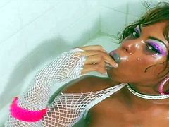 Pretty turned on wild ebony babe with delicious ass and colorful heavy make up in white fishnet blouse only stuffs her precious cunny with glass dildo in warm bathtub.