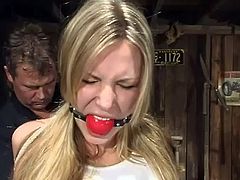 Hot blonde Harmony gets suspended in a basement. Then she gets pulled by the nipples and enjoys it when the dominator fucks her snatch with a dildo.