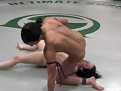 Two brunette girls wrestle in a ring and also finger each others pussies. After that the losing girl gets toyed in acrobatic poses with a strap-on.