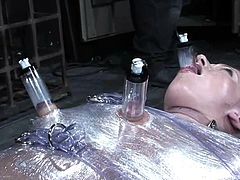 Slutty blonde Dia Zerva allows some guy wrap her in foil in a basement. Then the dude pulls the whore by the nipples and enjoys to listen to her moans.
