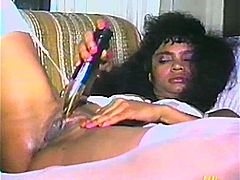 Fugly black chick is having fun with some dude in a vintage scene. She sucks and rubs the stud's boner devotedly and then drills her poontang with dildos.